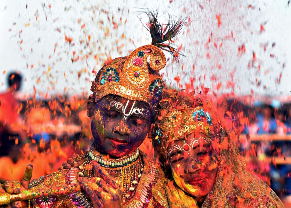 PHOTO: Tribal students from the Kalinga Institute of Social Science (KISS), dressed as Lord Krishna and Radha, face a rain of petals during Holi celebrations in the city of Bhubaneswar in Odisha, India on March 1, 2018. 