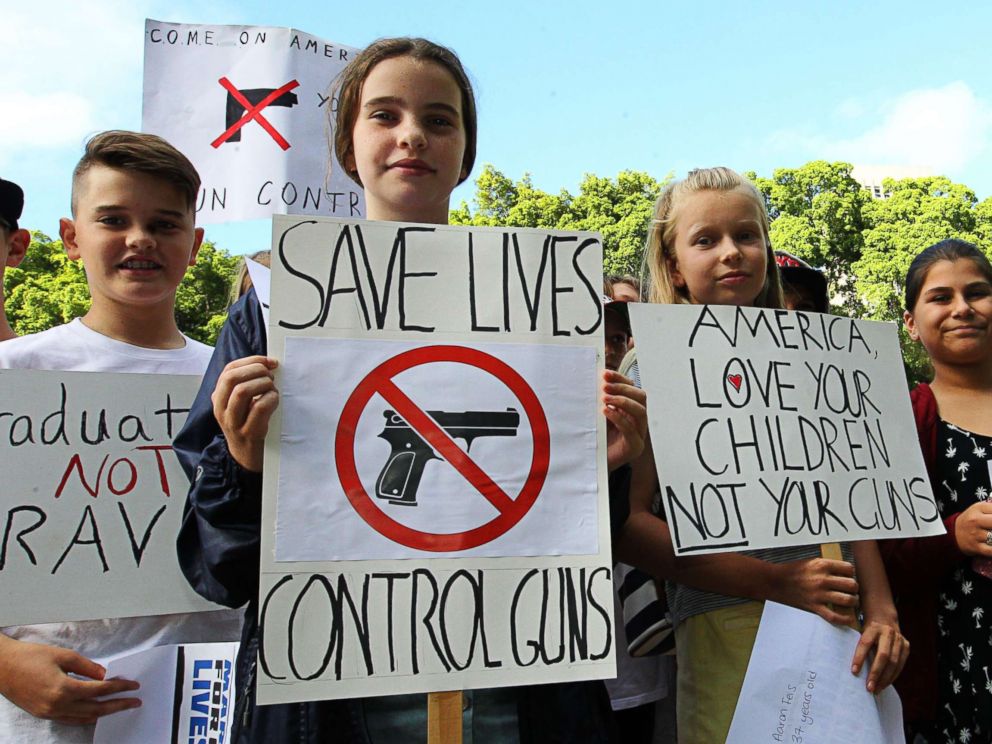 PHOTO: Young protesters hold placards at Hyde Park in Sydney, Australia, March 24, 2018, during the March for Our Lives protest.