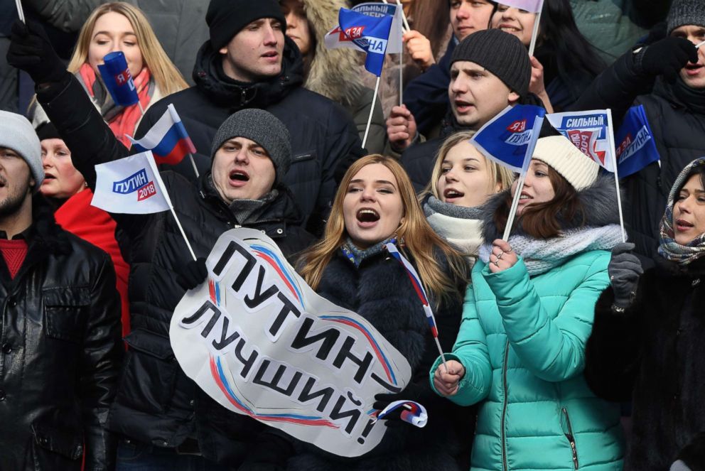 PHOTO: Supporters of presidential candidate, President Vladimir Putin attend a pre-election rally at the Luzhniki stadium in Moscow, March 3, 2018. The placard reads Putin is the best!.