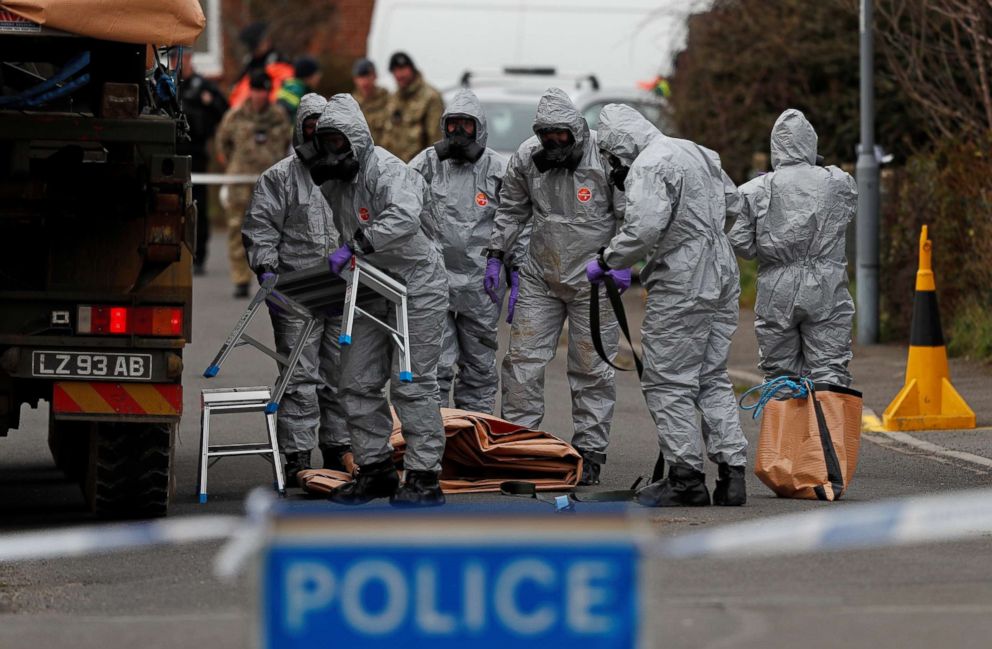 PHOTO: British Military personnel wearing protective coveralls work to remove a vehicle connected to the March 4 nerve agent attack in Salisbury, from a residential street in Gillingham, southeast England on March 14, 2018. 