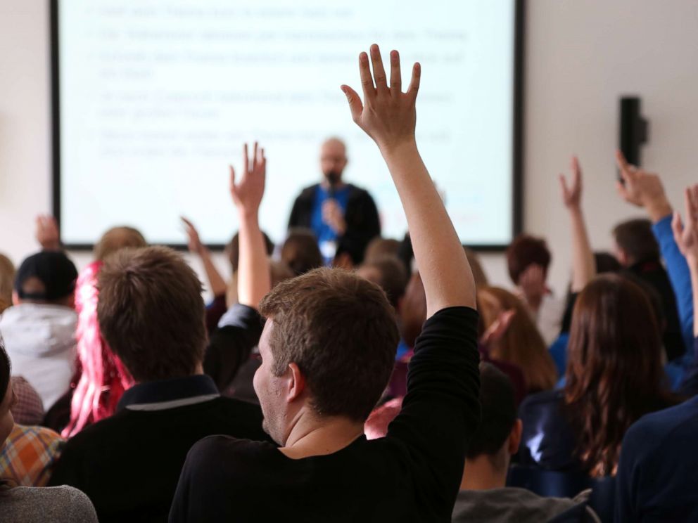 PHOTO: College students raise their hands in class in an undated stock photo.