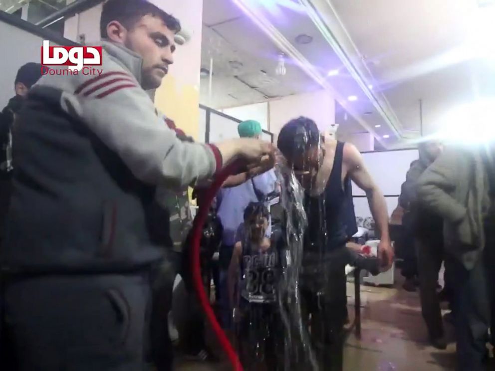 PHOTO: An image grab taken from a video released by the Douma City Coordination Committee shows volunteers spraying a man with water at a make-shift hospital following an alleged chemical attack on the rebel-held town of Douma, Syria, April 7, 2018.