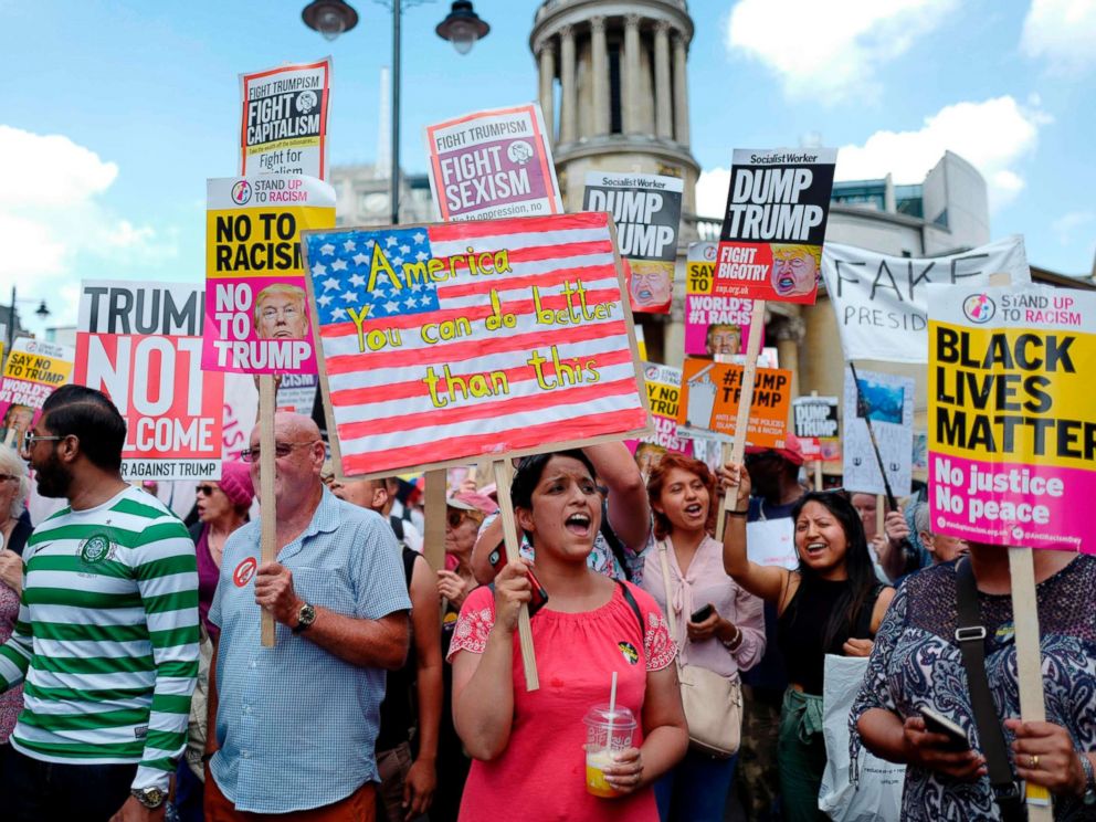 PHOTO: Protesters gather with placards to take part in a march and rally against President Donald Trumps visit to Britain, on July 13, 2018 in London.