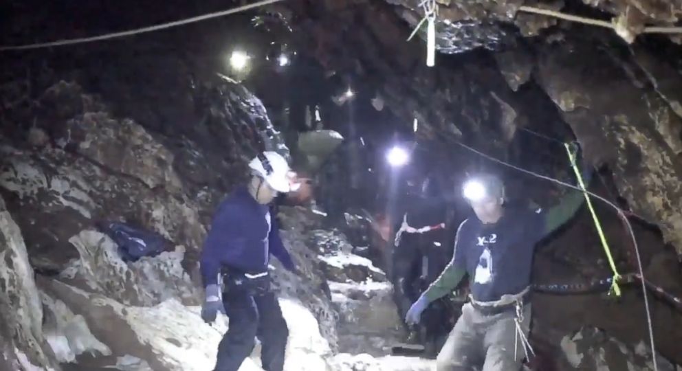 PHOTO: Rescuers carry one of the boys on a stretcher through a narrow steep passage in the cave as they trudge their way to safety. 