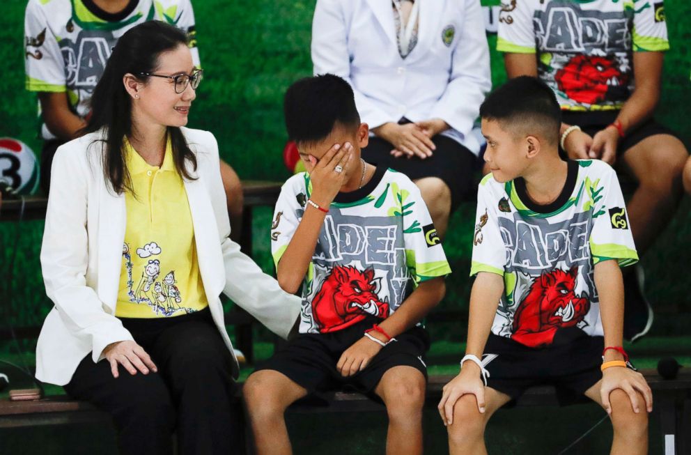 Rescued soccer player Titan Chanin Vibulrungruang reacts after paying respect to a portrait of Saman Gunan, the Thai Navy SEAL diver who died in the rescue attempt, during a press conference in Chiang Rai, Thailand, July 18, 2018.